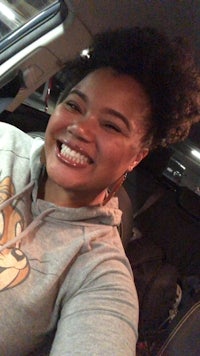 a woman smiling in a car